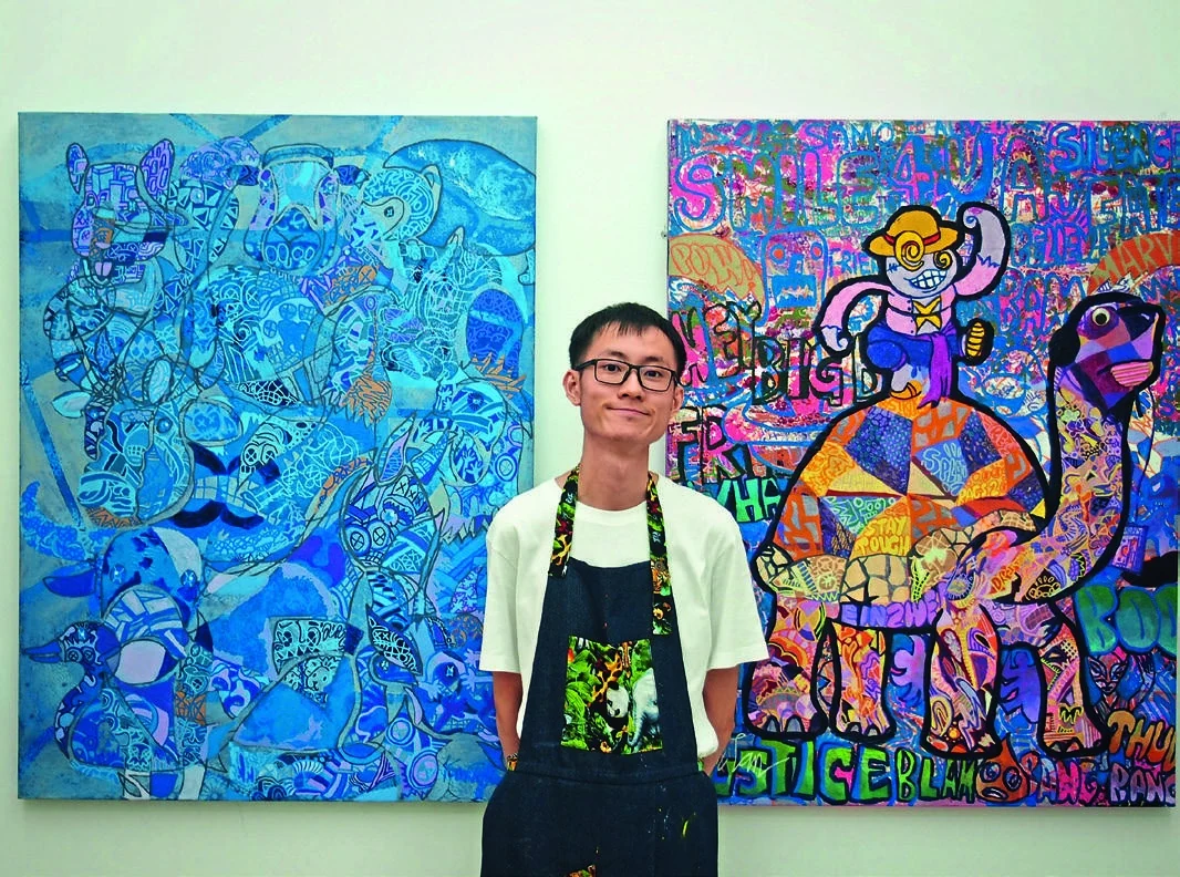 Tan Ken Ming pictured with his work in The Expat’s May issue.