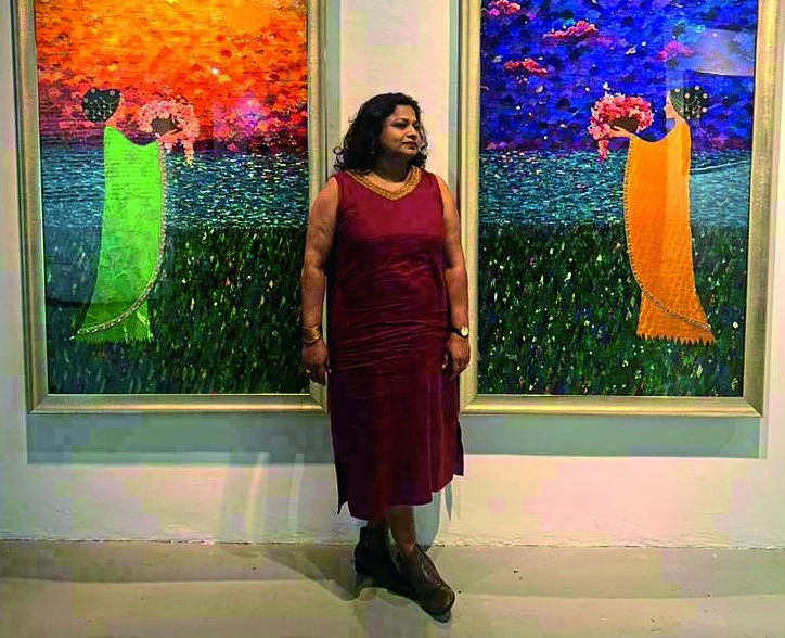 Tulika Prakash with her paintings, photographed for The Expat.